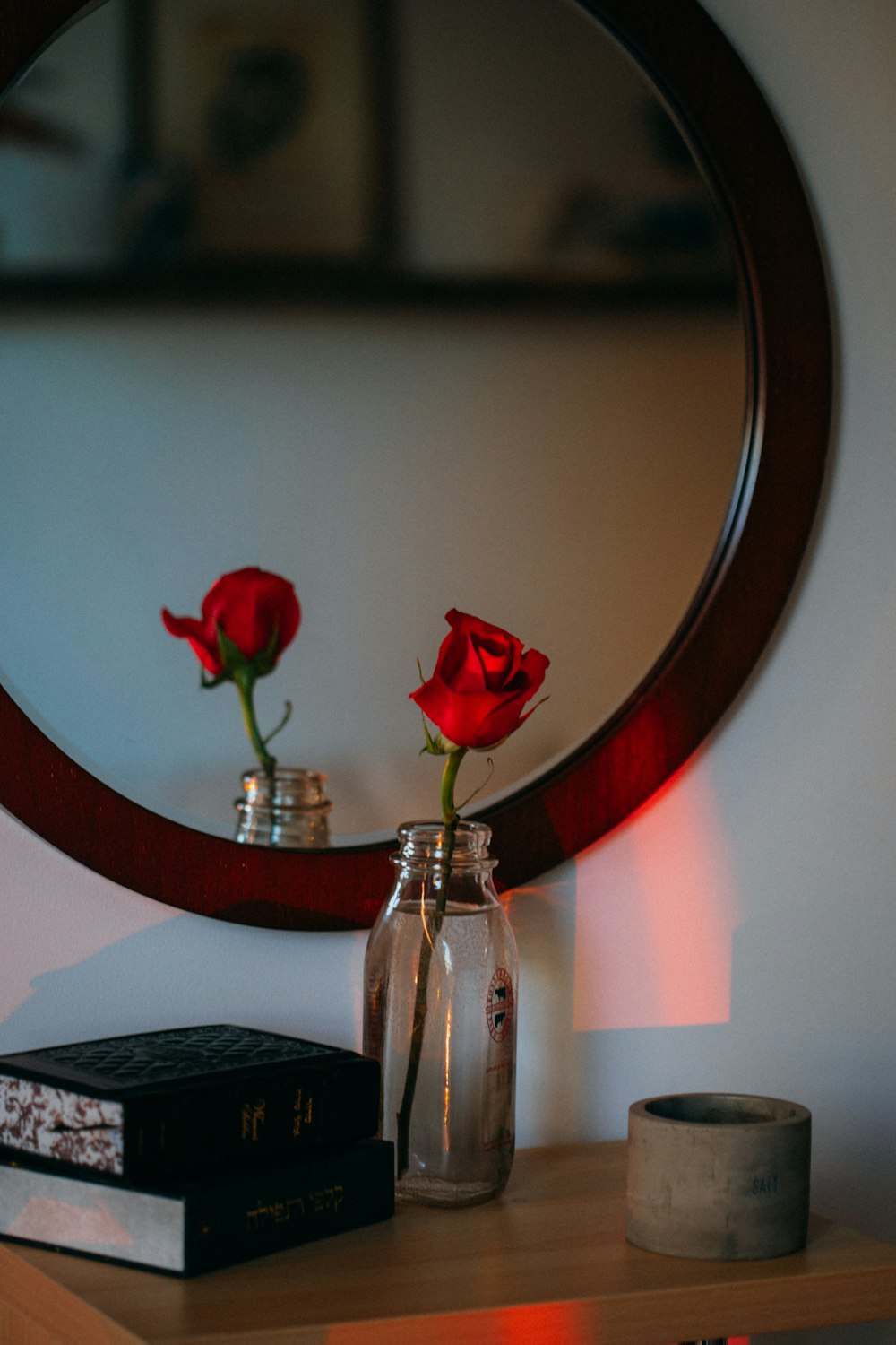 a mirror sitting on top of a wooden table