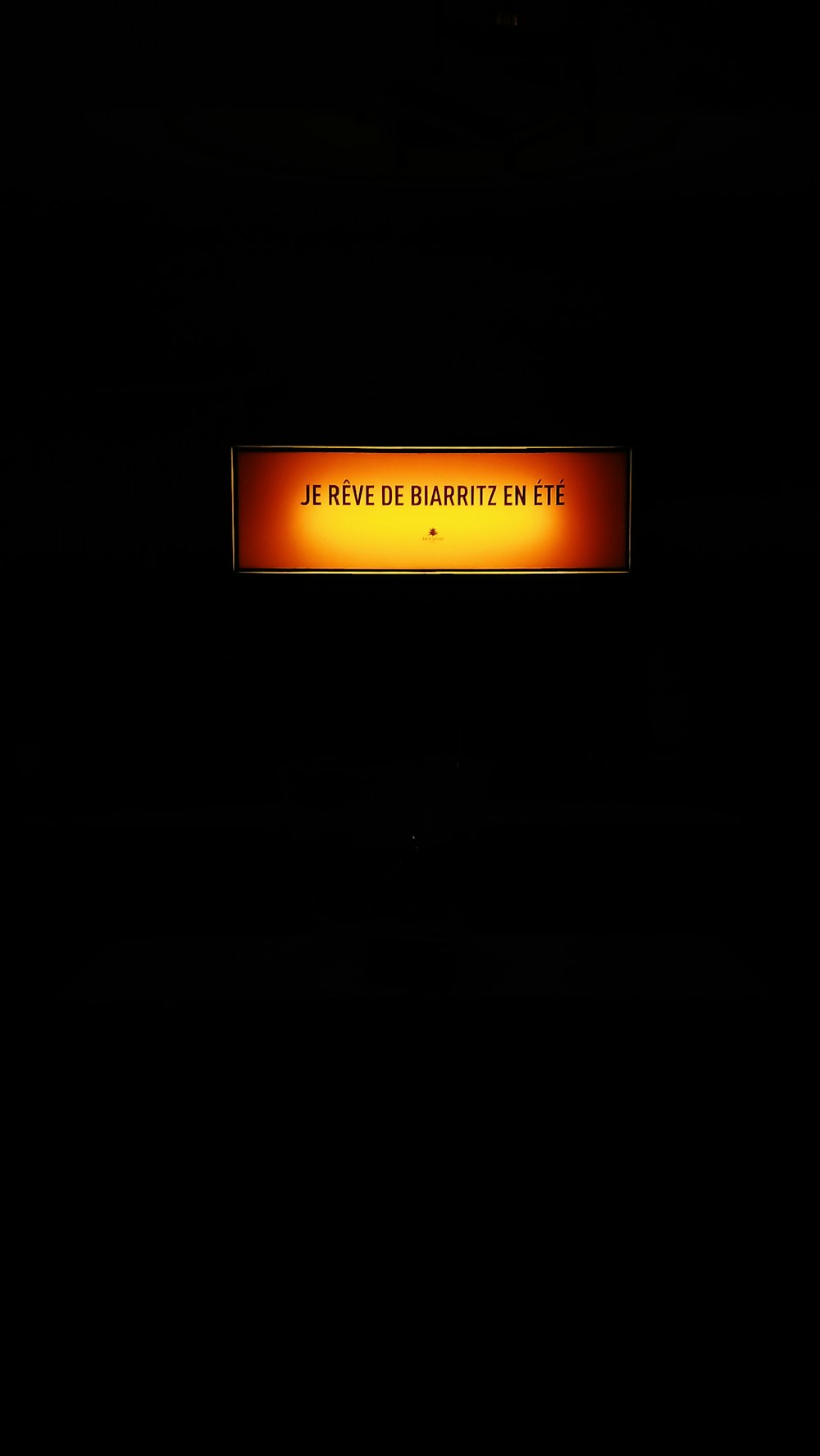 a sign that is lit up in the dark
