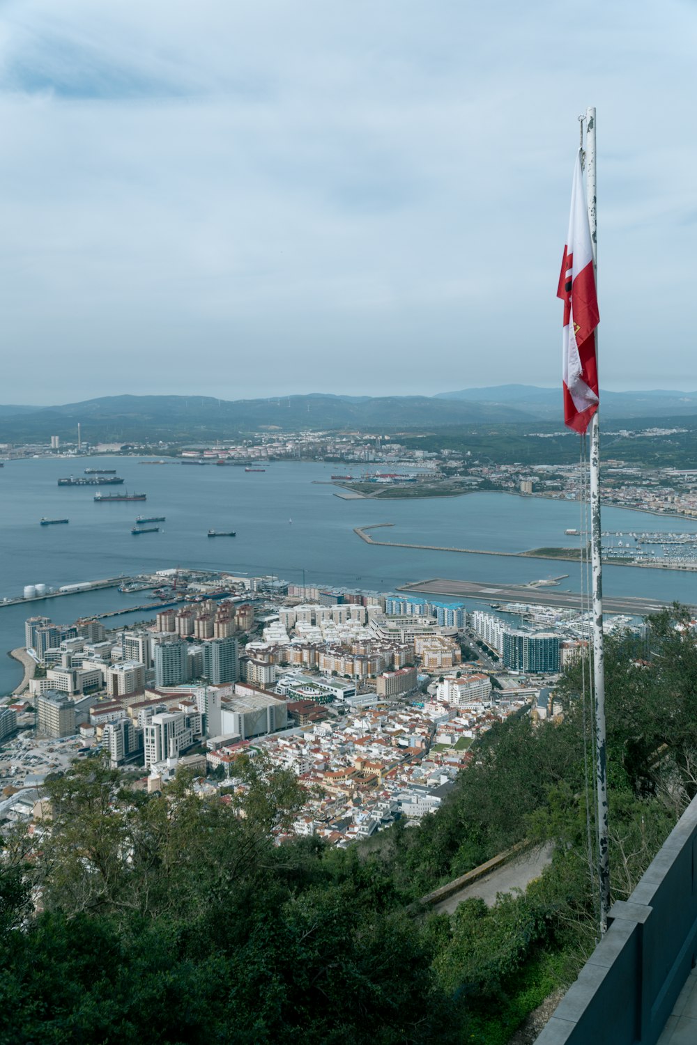 a canadian flag flying on top of a tall building