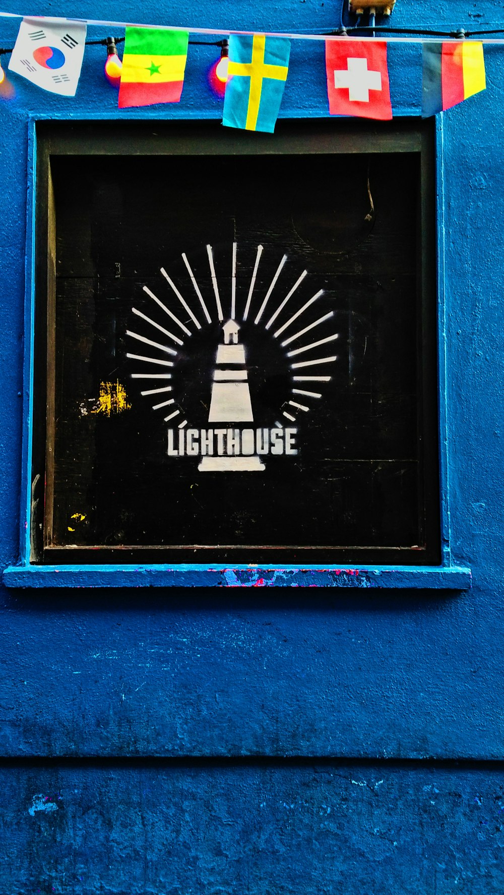 a blue building with a light house sign on it
