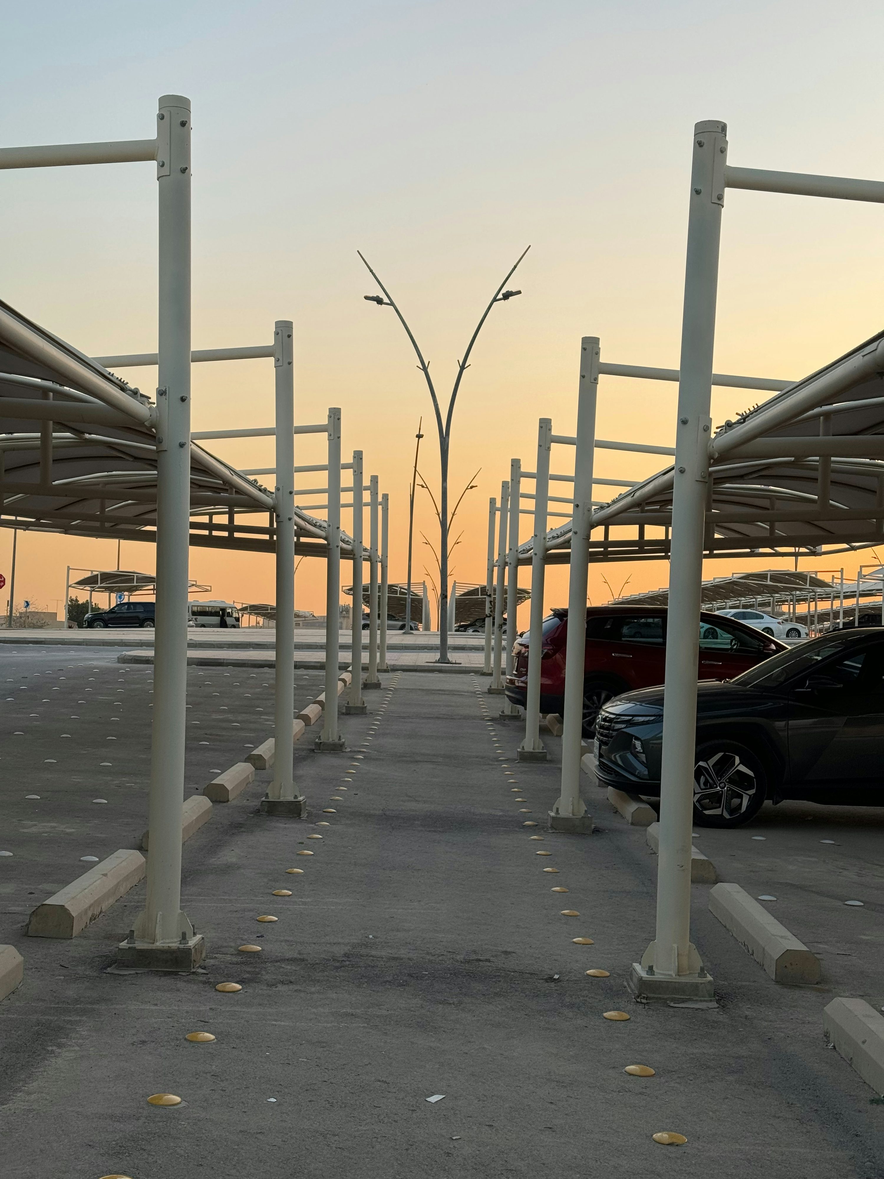 a parking lot with a row of parked cars