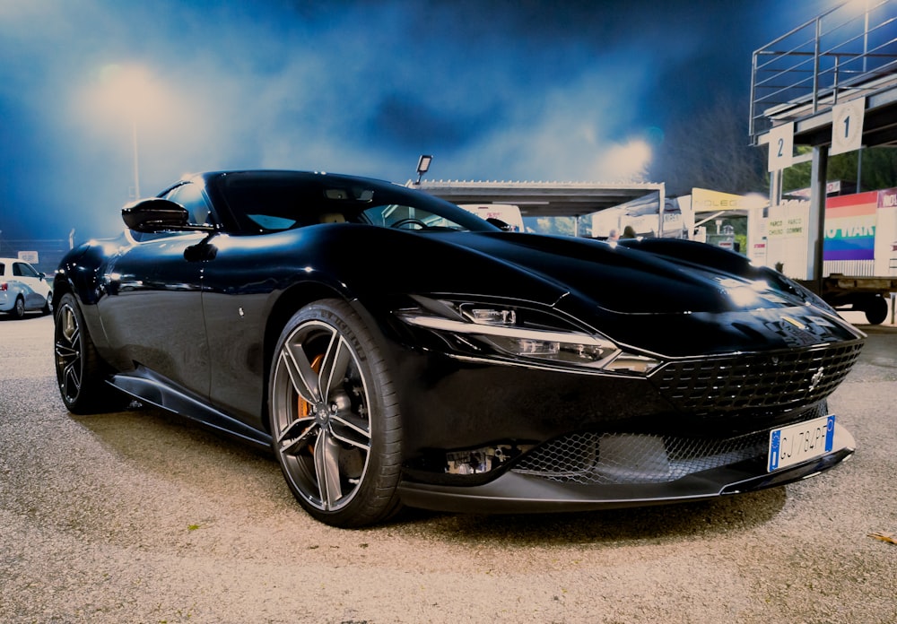 a black sports car parked in a parking lot