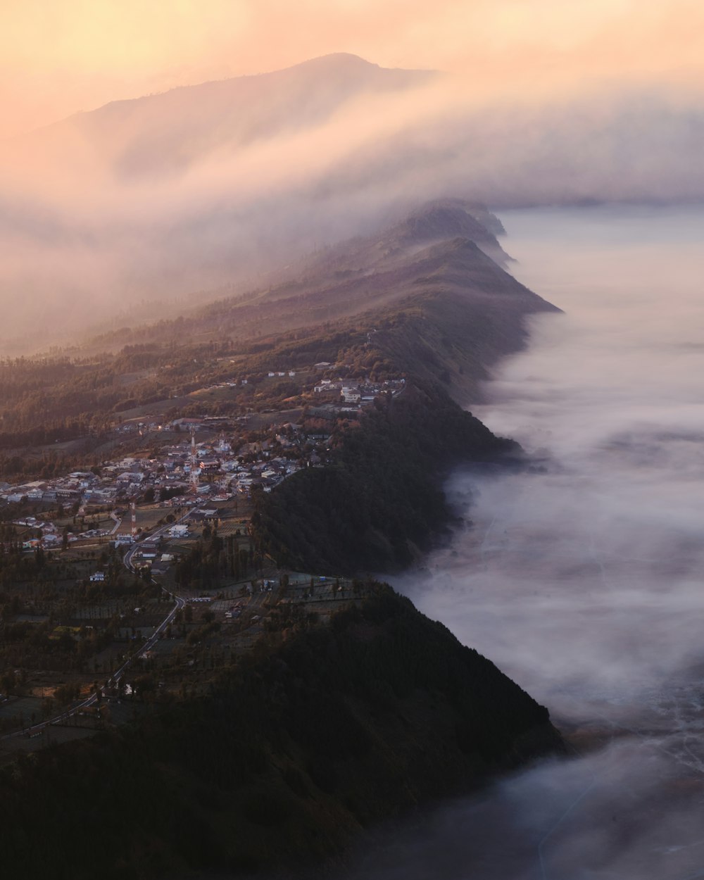 a view of a town and a mountain covered in fog