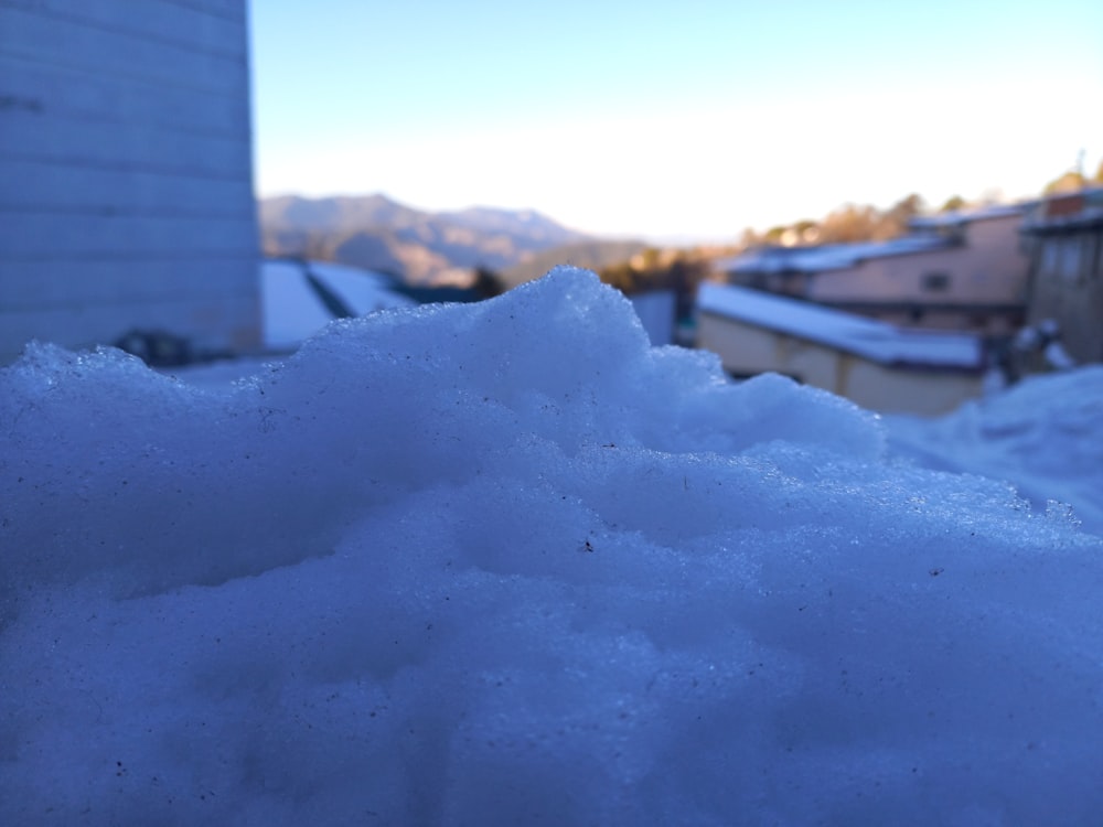 a pile of snow sitting next to a building