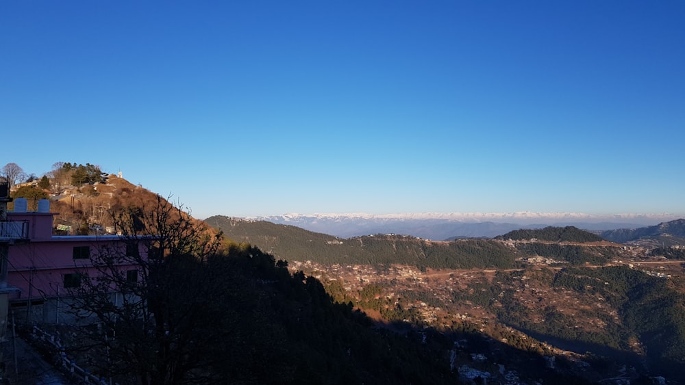 a view of the mountains from a hill top