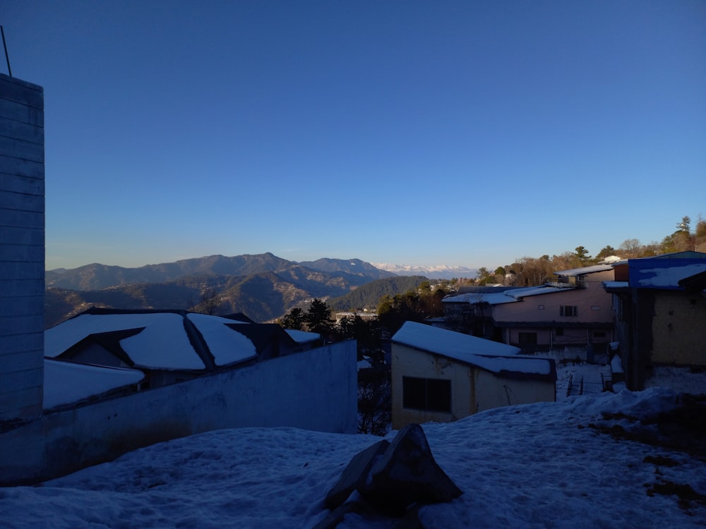 a view of a snowy mountain range from a rooftop