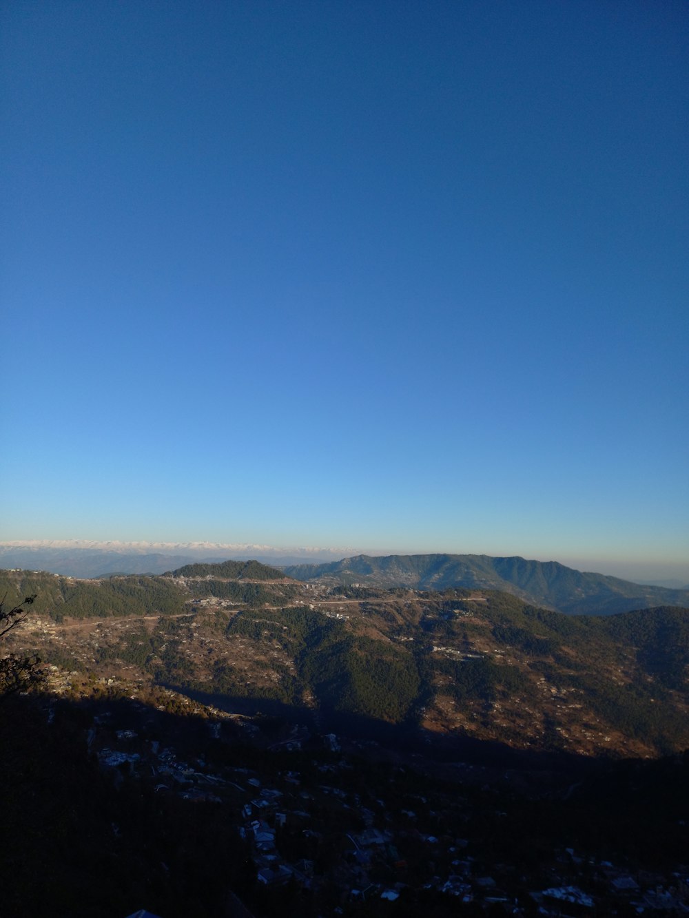 a view of the mountains from a hill top