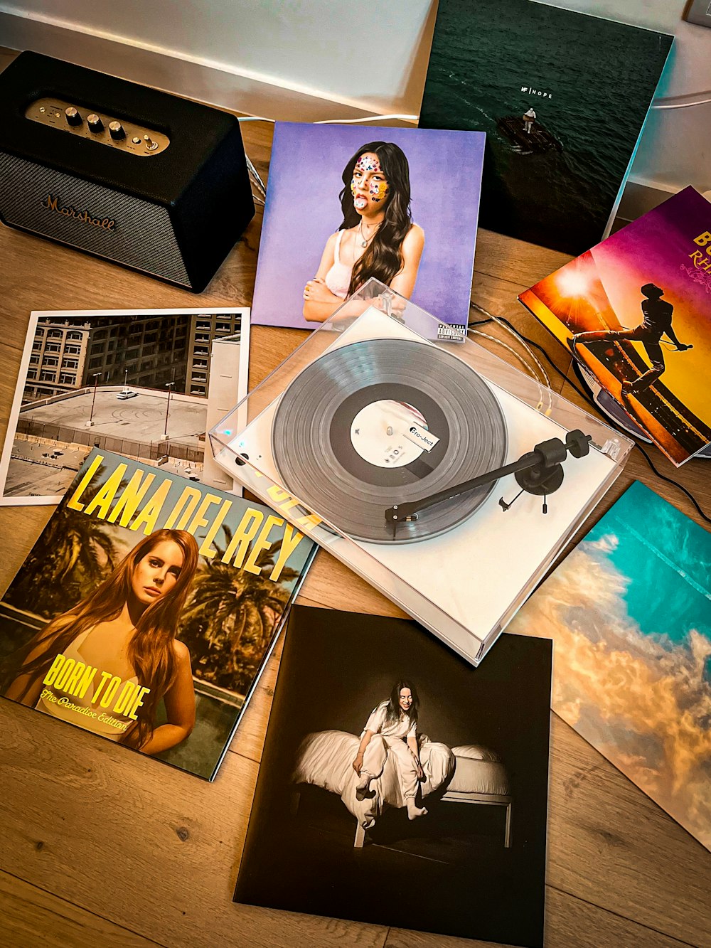 a wooden table topped with lots of records