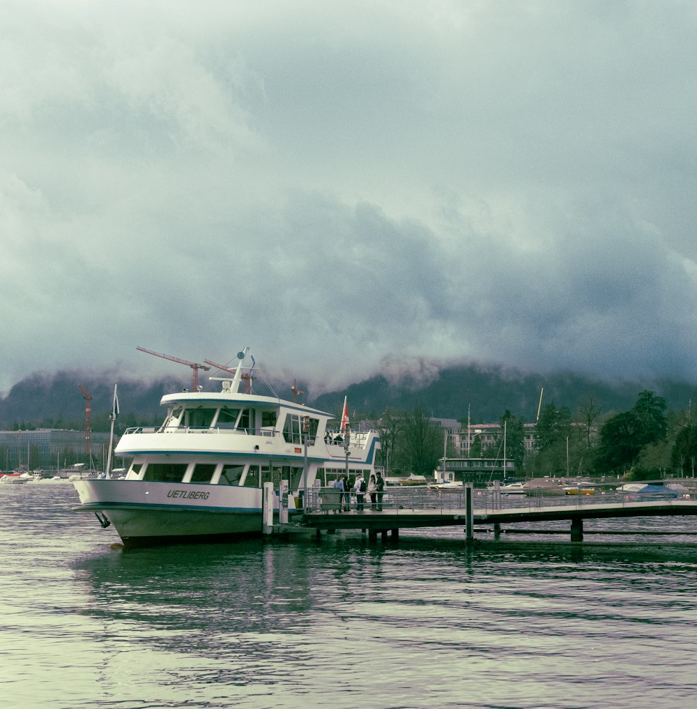 a boat is docked at a dock on a cloudy day