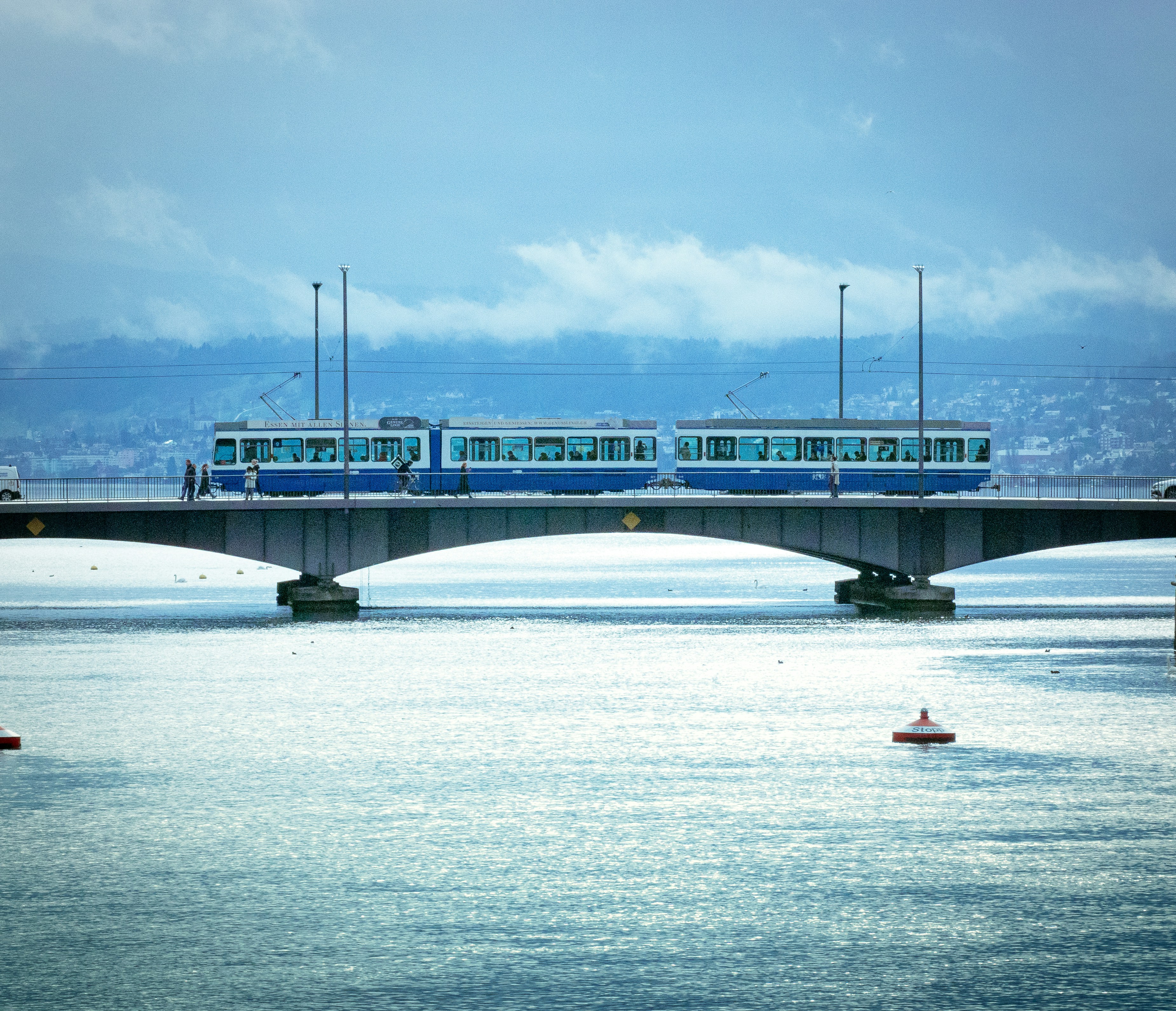 A train on a bridge over a body of water photo – Free Train Image on ...