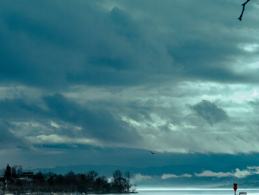 a large body of water under a cloudy sky