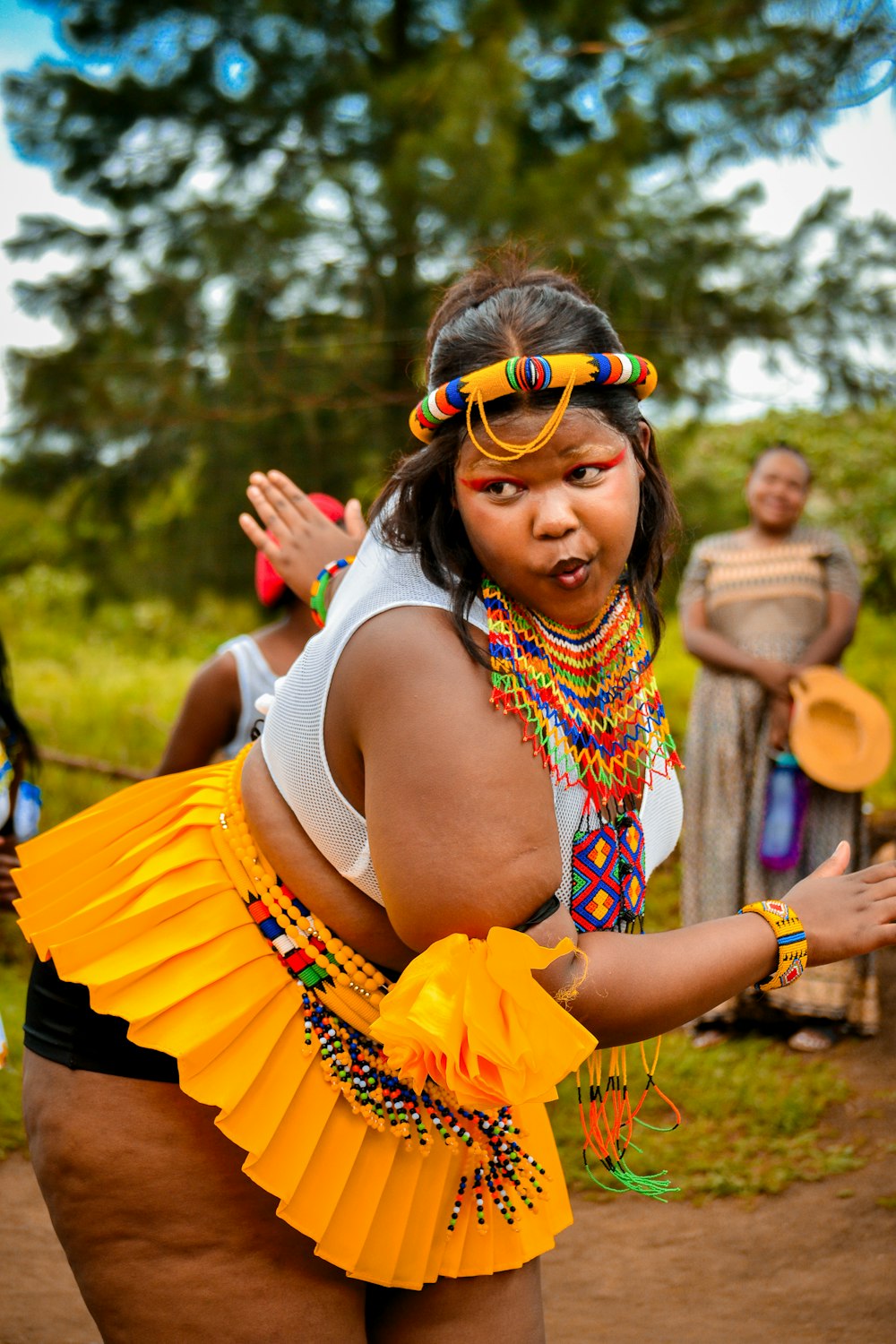 a woman in a yellow skirt is dancing