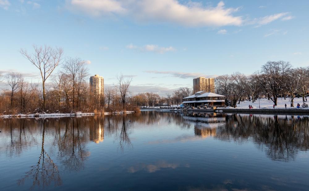 a body of water surrounded by trees and buildings