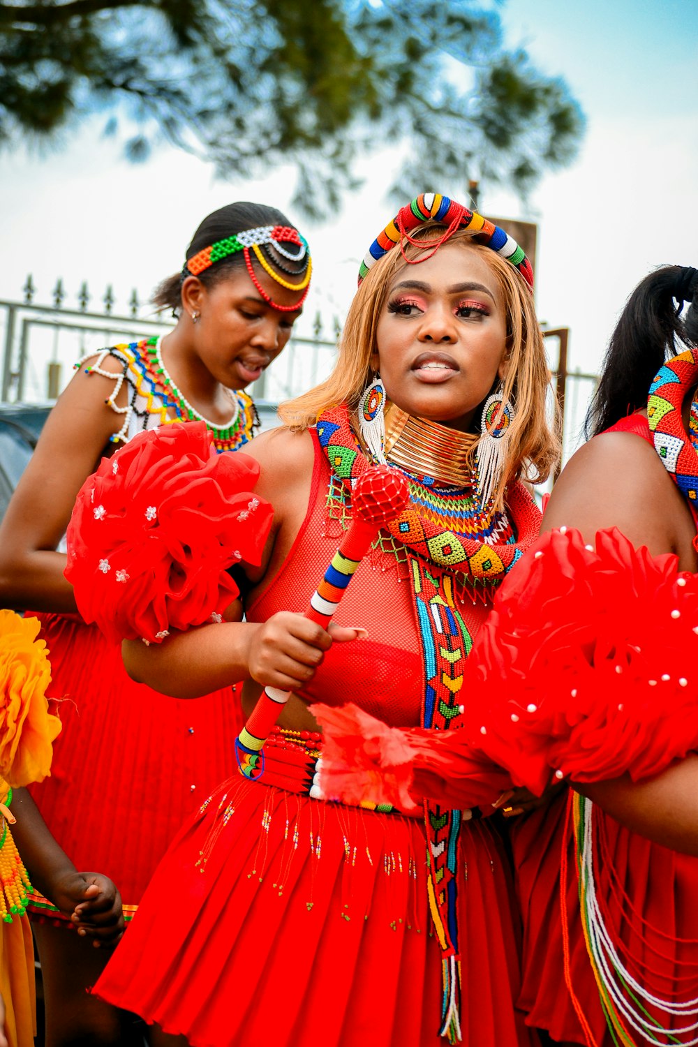 a group of women in red dresses standing next to each other