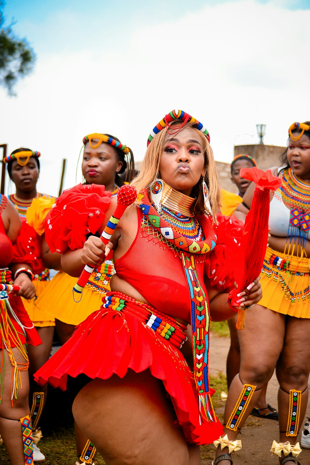 a group of women dressed in red and yellow