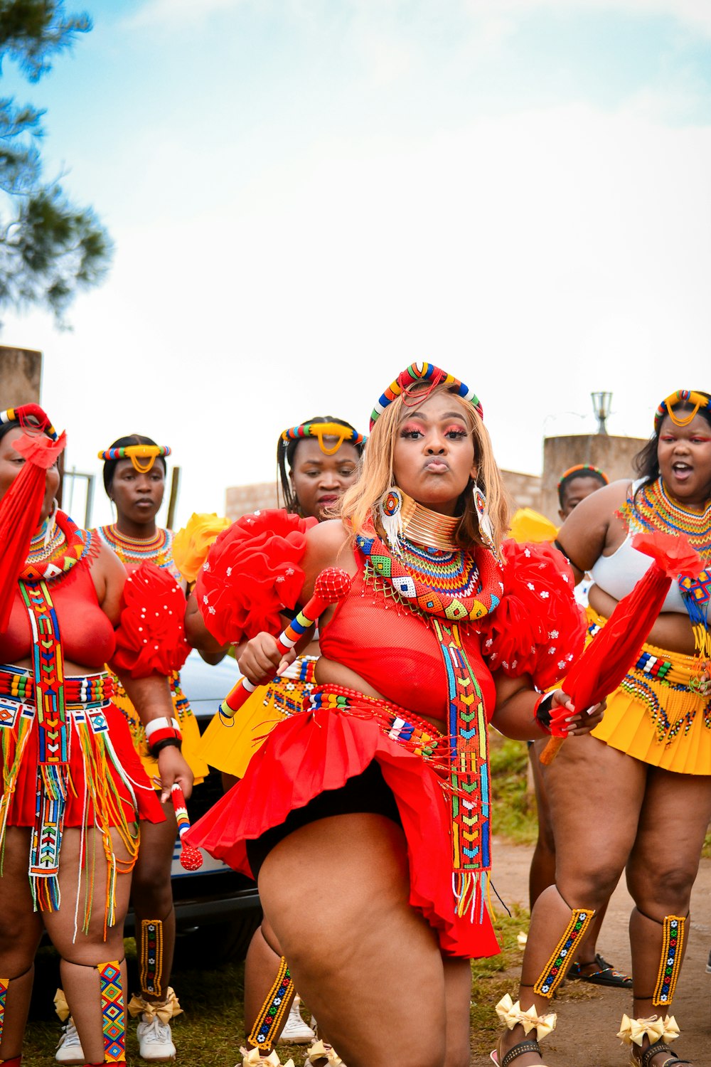 a group of women in red and yellow outfits