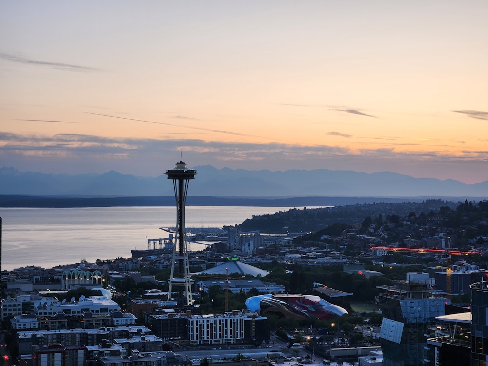 a view of a city with a lake and mountains in the background