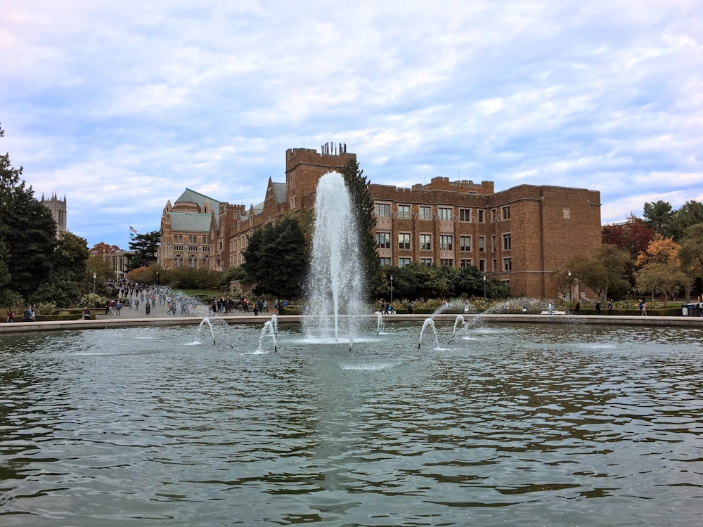 a water fountain with a building in the background