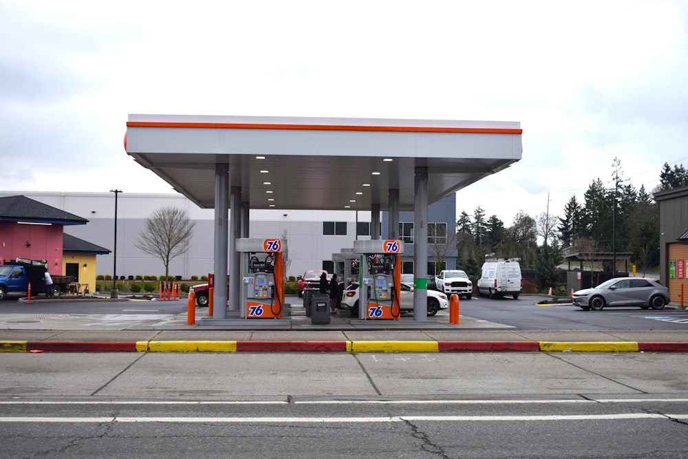 a gas station with cars parked in the lot