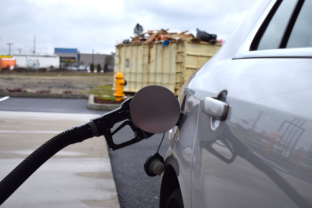 a gas pump is connected to a car at a gas station