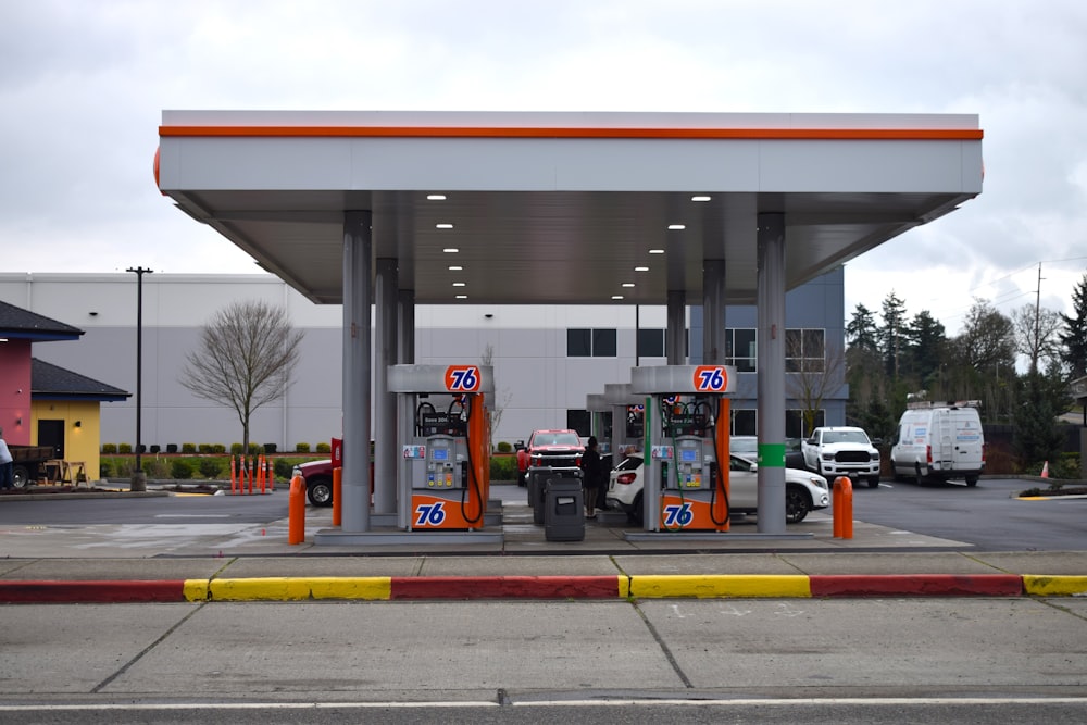 a gas station with a few cars parked in front of it