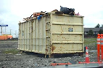 a dumpster sitting on top of a pile of rubble