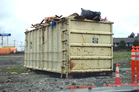 a dumpster sitting on top of a pile of rubble