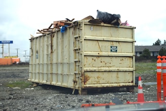 a dumpster sitting on top of a pile of rubble