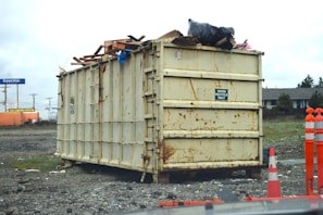 a dumpster sitting on top of a pile of rubble