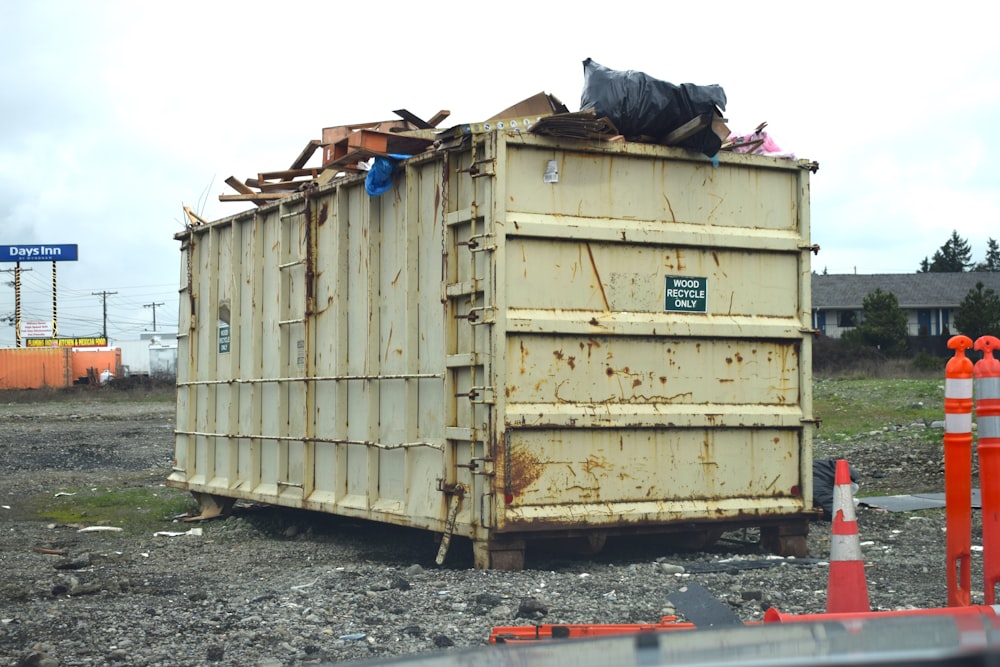 a dumpster sitting on top of a pile of rubble