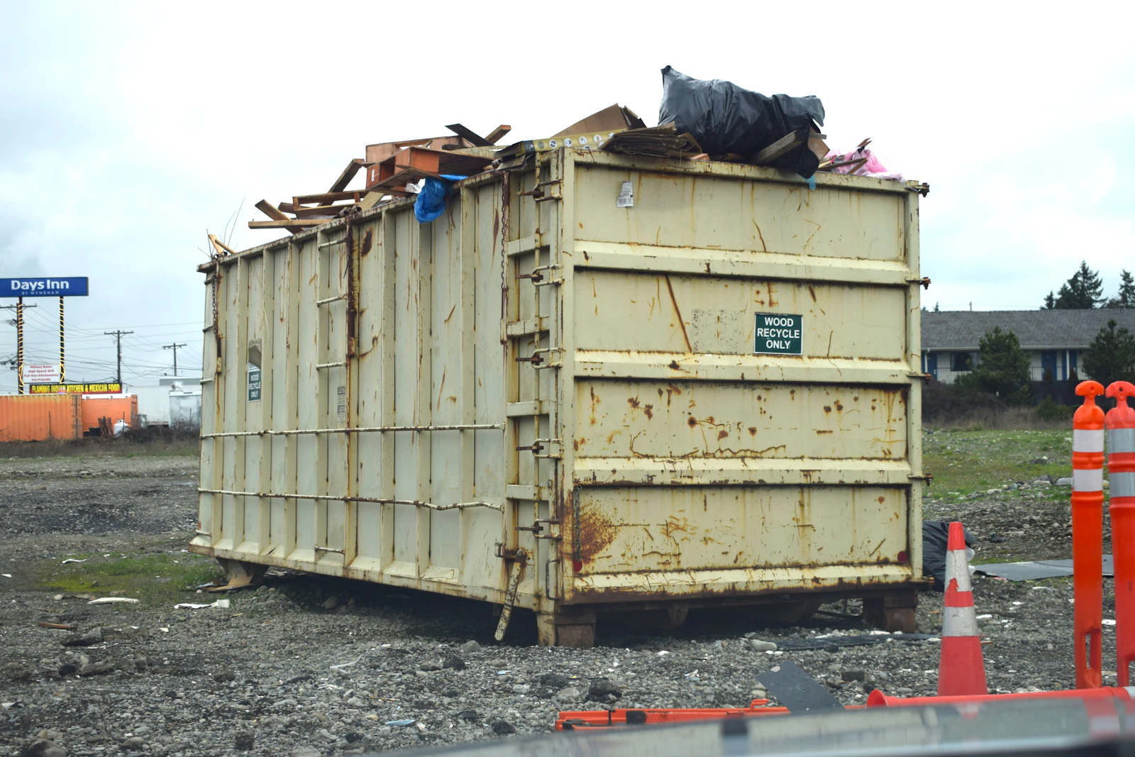 Real roll-off dumpster loaded with construction debris and rubble at a Tampa-area job site