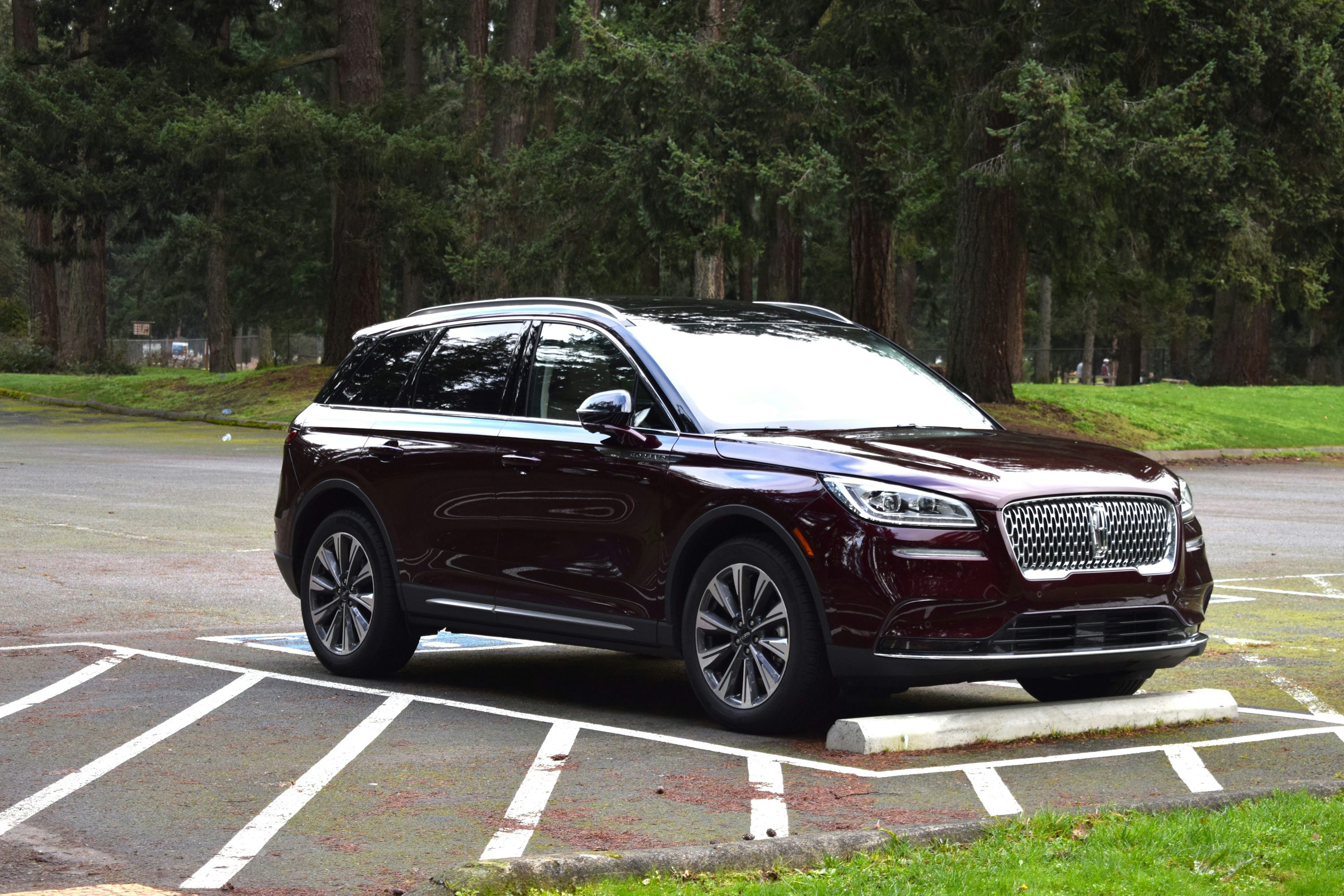 a car parked in a parking lot with trees in the background