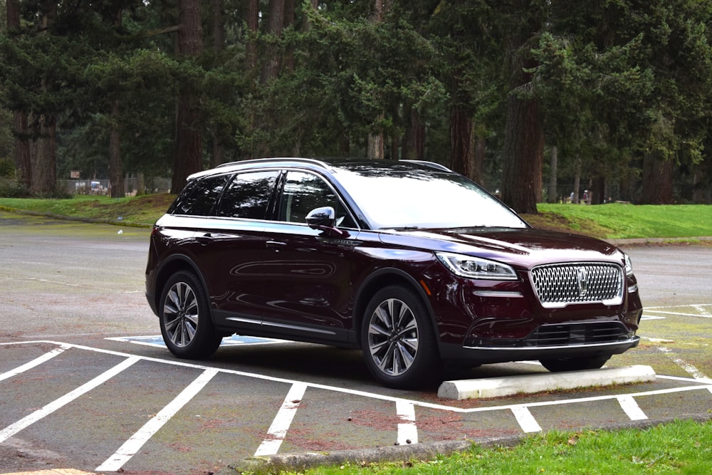 a car parked in a parking lot with trees in the background