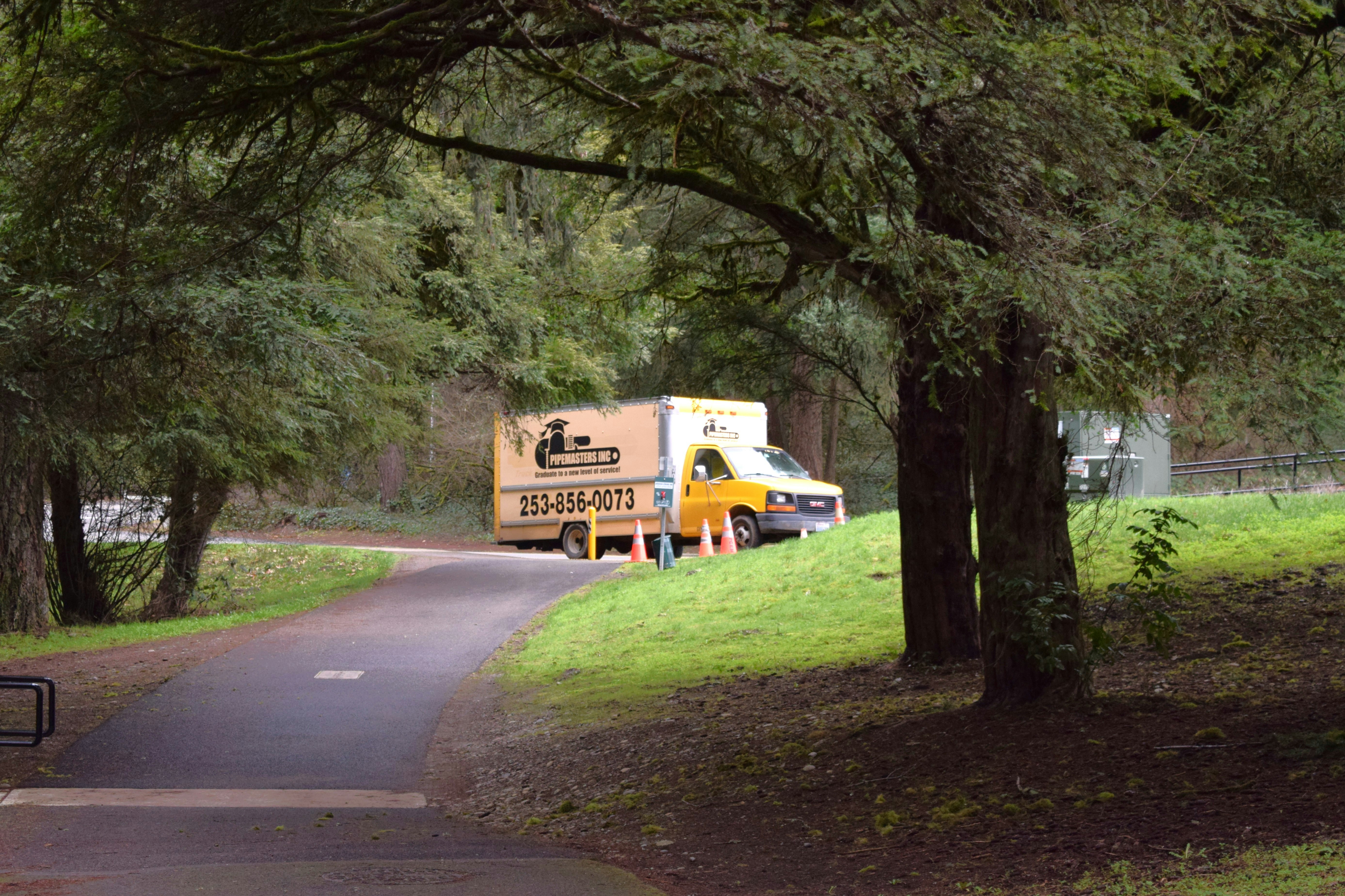 a yellow truck parked on the side of a road