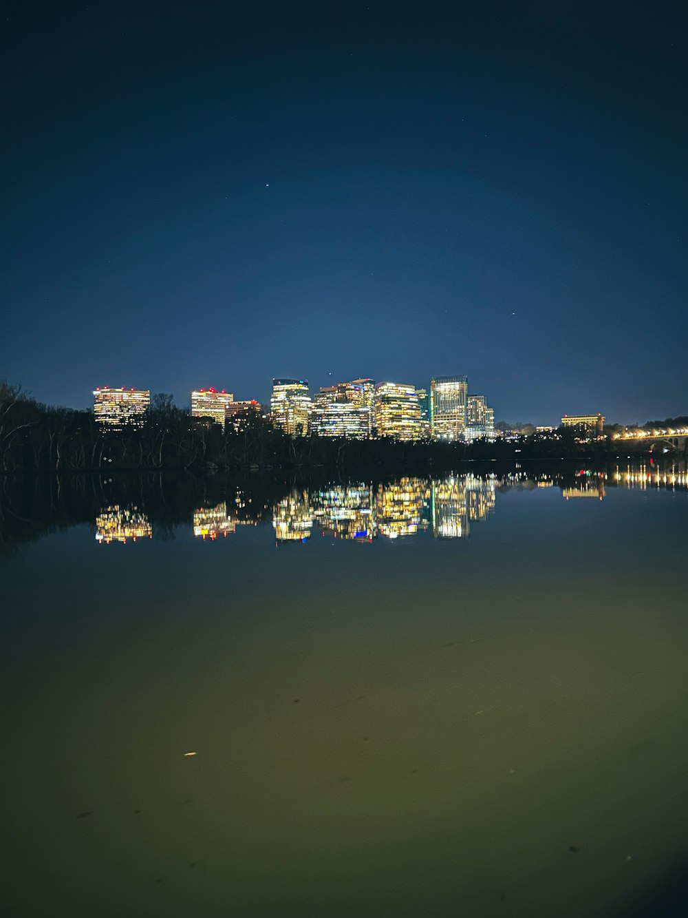 a view of a city at night from across a lake