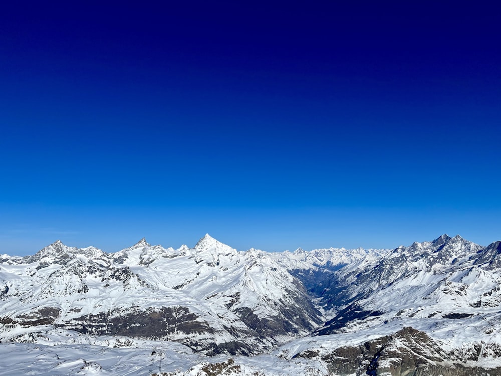 a view of a mountain range with snow on it