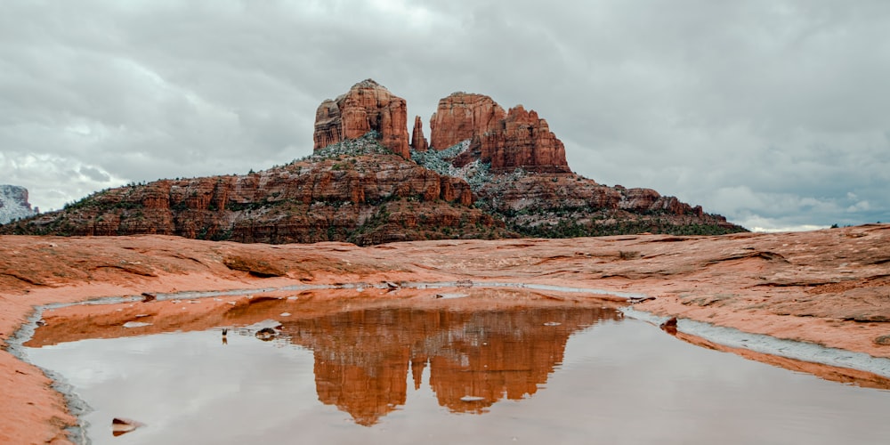 a mountain with a reflection in a pool of water