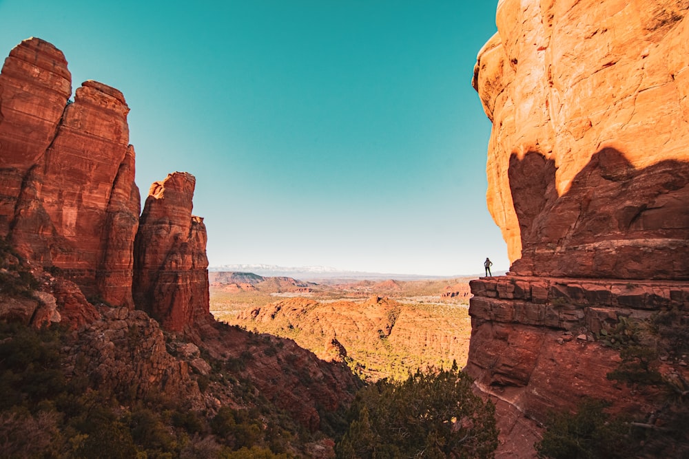 a person standing on top of a cliff