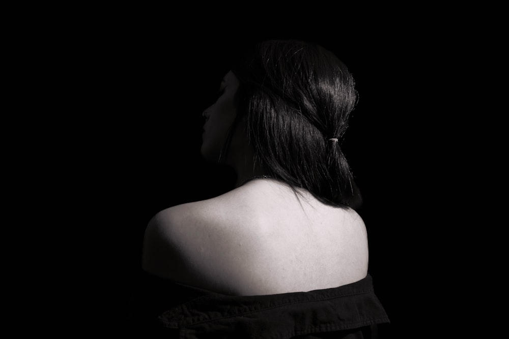 a black and white photo of a woman's back