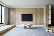 a living room with a television and a large window