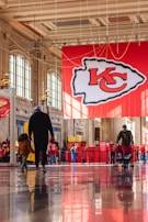 a group of people walking through a lobby