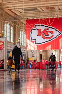 a group of people walking through a lobby