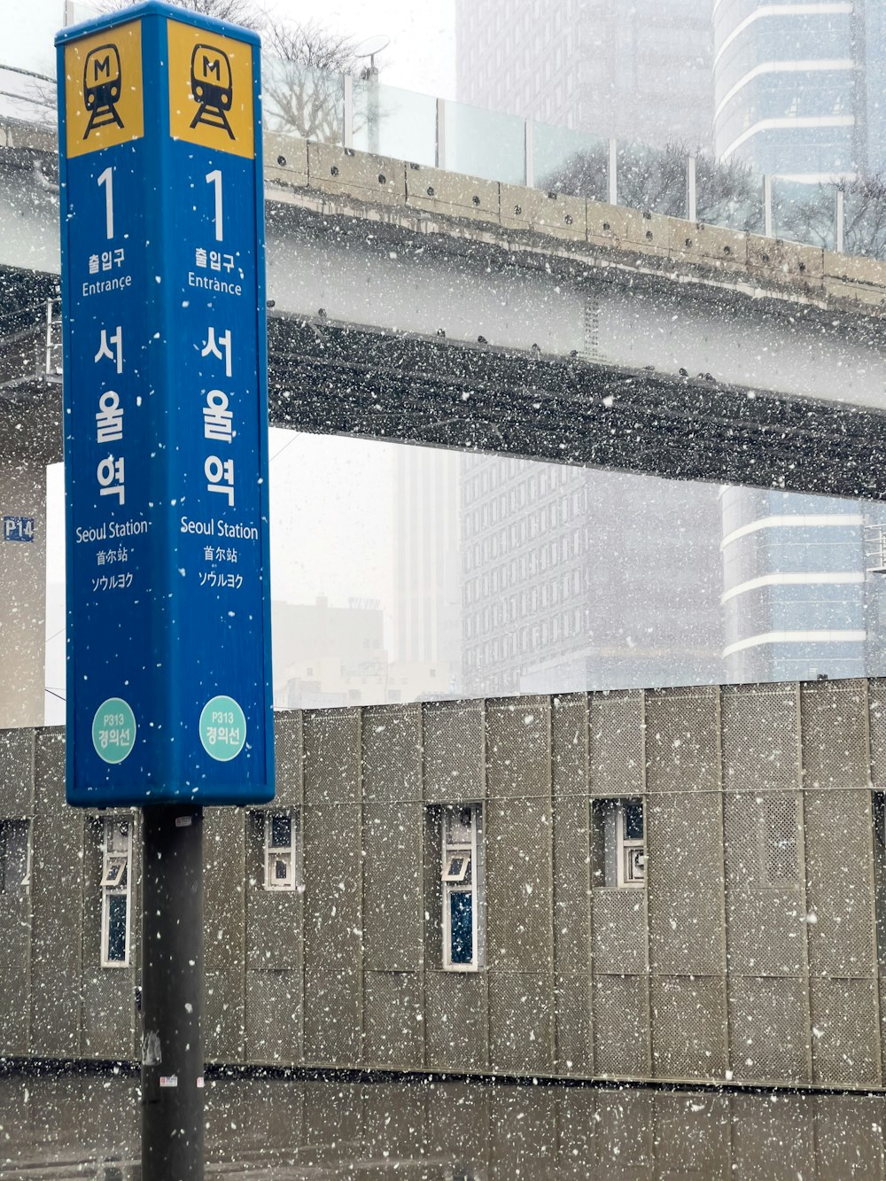 a blue sign sitting on the side of a road