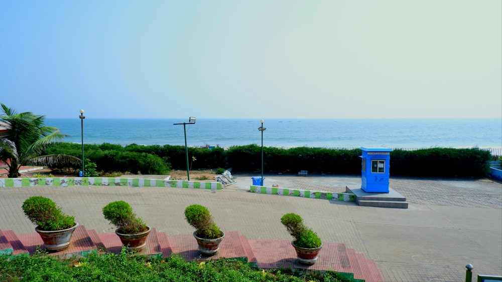 a blue phone booth sitting on the side of a road