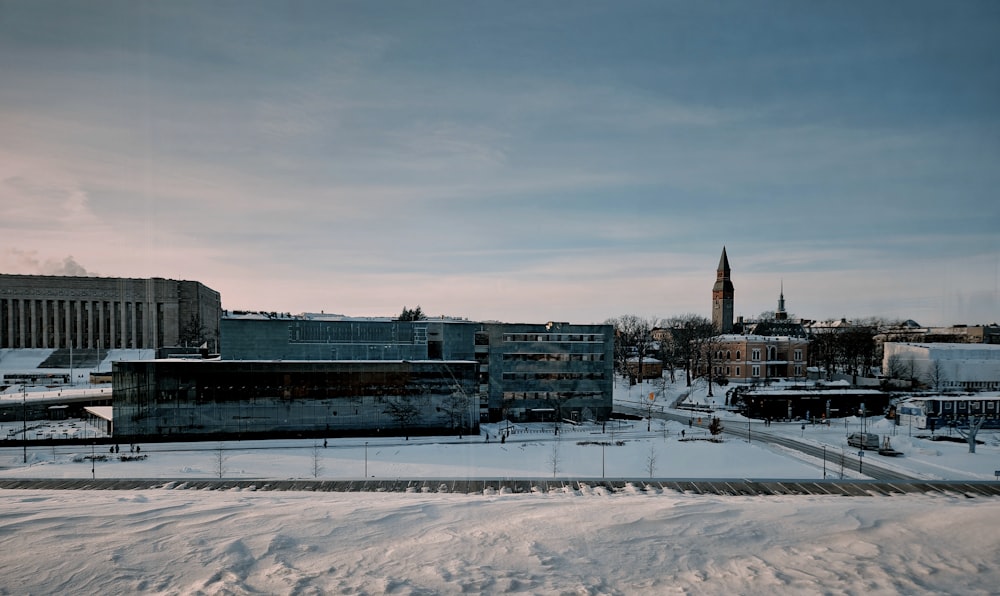 Una vista de una ciudad nevada con una torre de reloj en la distancia