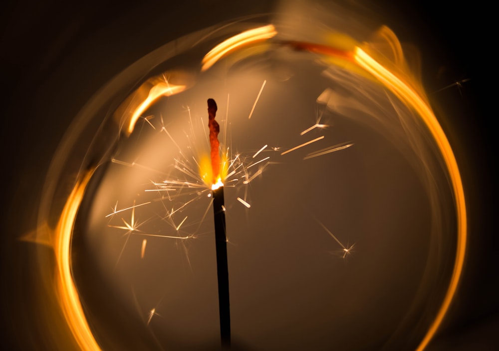 a close up of a sparkler on a black background