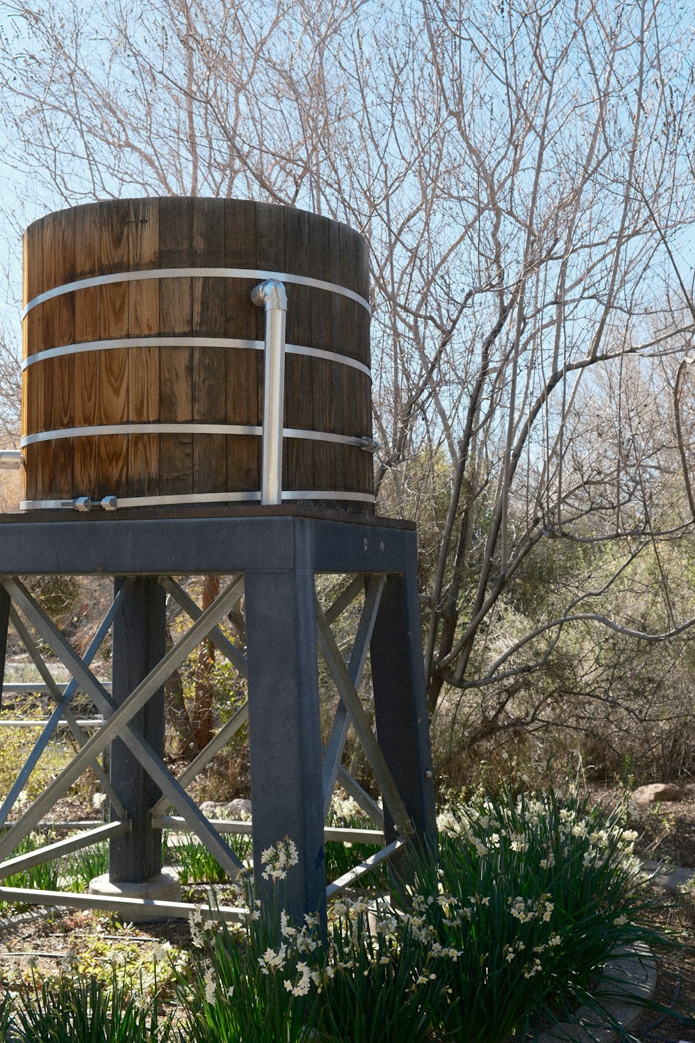a large wooden barrel sitting on top of a metal stand