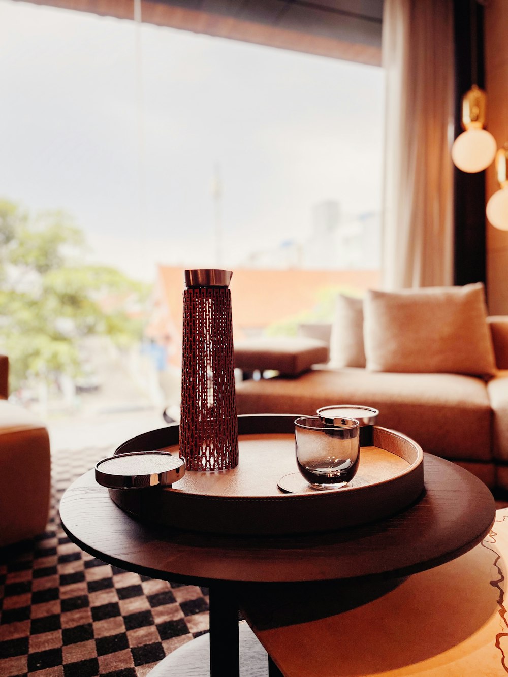 a table with a glass and a vase on it