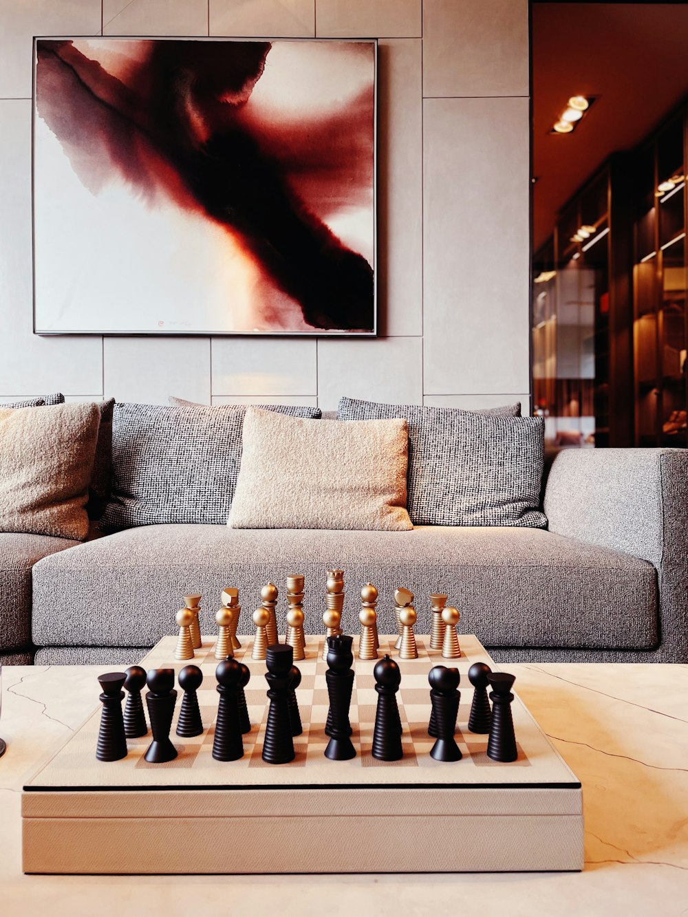 a living room with a couch and chess set