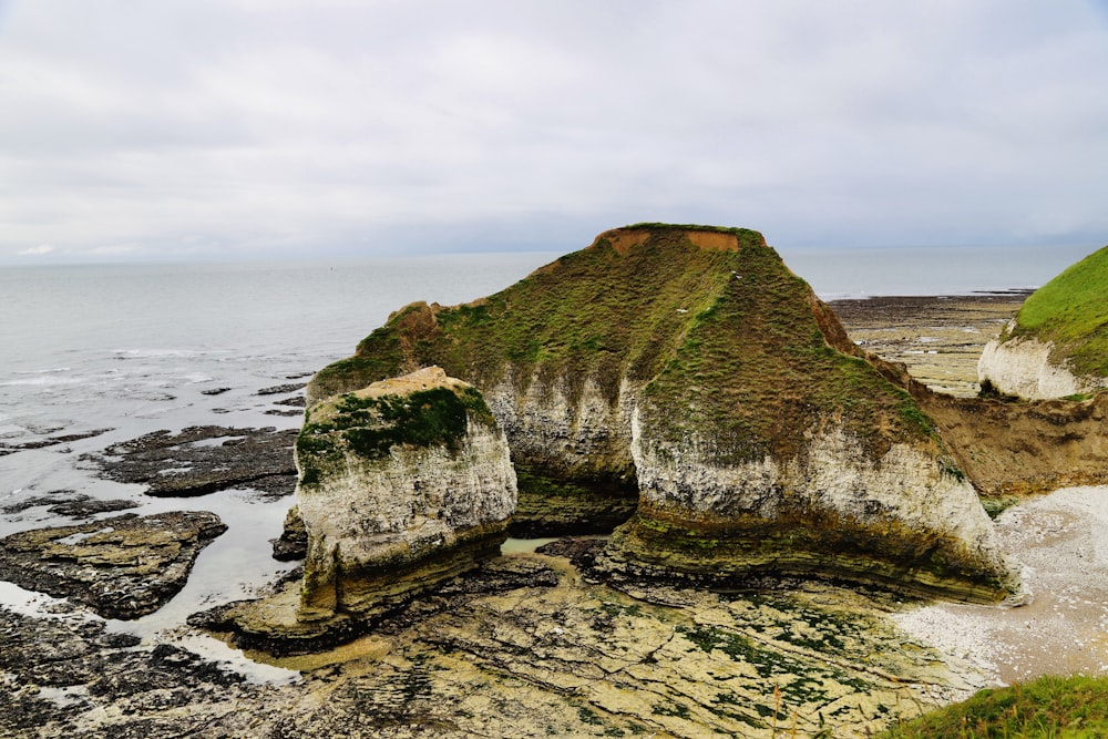 a rock formation on the shore of a body of water